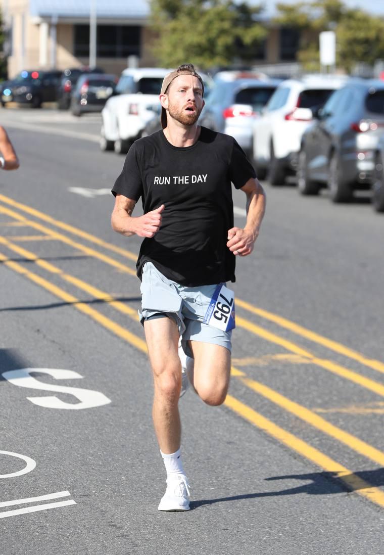 Ian Campbell running in a Run The Day shirt at a road race